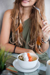 Obraz na płótnie Canvas Close up photo of white bowl with healthy food. Smiling girl in the background