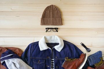 Top view of  men winter outfit and accessories on wood background , retro clothing concept, blue...