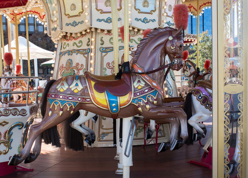 Brown vintage decorative carnival horse on merry go round carousel in fairground