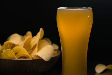 Unfiltered beer and potato chips in the bowl