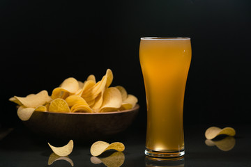 Unfiltered beer and potato chips in the bowl
