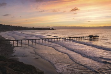 Fototapeta na wymiar Dramatic Sunset Sky, Scripps Pier and La Jolla Shores Beach below UCSD north of San Diego California