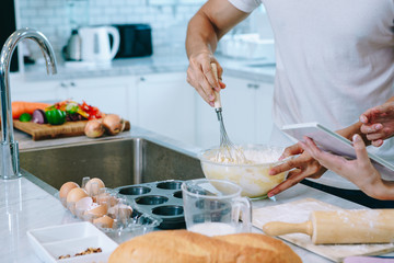 Asian teen couple are helping to make dinner. And bakery together happily. On Valentine's Day in their home.