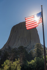 Devil's Tower With Sun Shining through American Flag.
