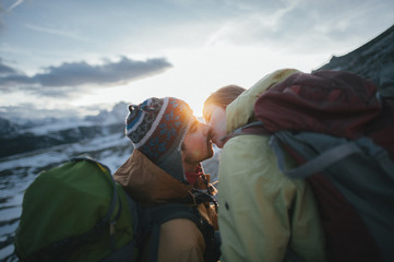 happy retired couple on vacation hugging in a valley in the Dolomites mountains