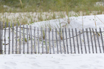 Fototapeta premium Beach Scene with white sand and a fence.