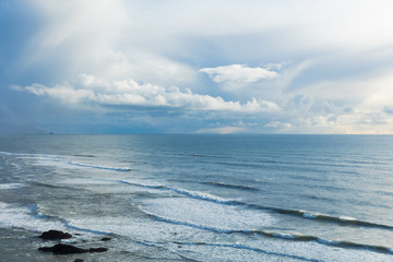 Canon Beach. Oregon Coast. Haystack Rock. Pacific Northwest coastline. Ocean waves. Cloudy sunset. 