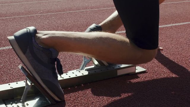 Lean runner beginning race from starting blocks, world championship in athletics