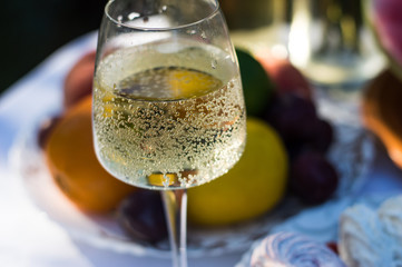 A bottle of wine on a background of fruits and cakes
