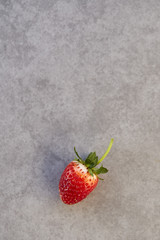 Fresh strawberry on gray