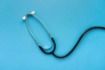Stethoscope on light blue background