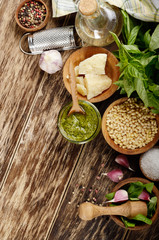 Top view of Pesto sauce ingredients and utensils on wood table