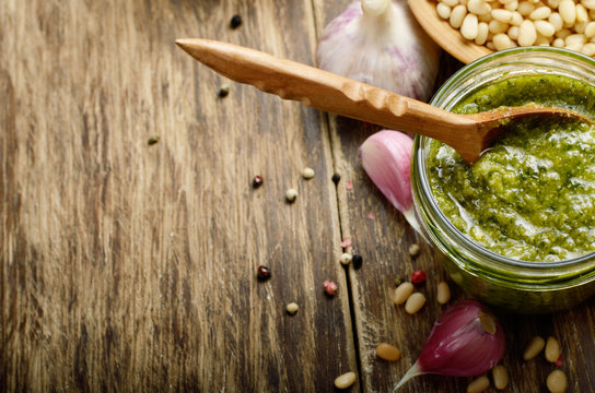Top view of Pesto sauce and ingredients on wood table with copy-space