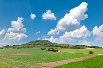 Fototapeta na wymiar national mystic hill Rip, Central Bohemia, Czech republic - spring landscape with green fields and blue sky with clouds