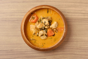 Chicken curry in wooden bowl 