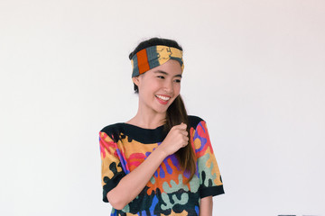 Fashion Portrait of Young cute asian woman wearing  80’s vintage colourful cloth and headband