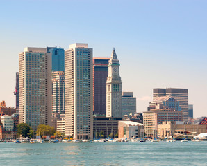 Fototapeta na wymiar Boston harbor and cityscape. Skyline of downtown district office and apartment buildings on the waterfront. Boston, Massachusetts, USA