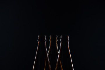 Silhouettes glass bottles for beer on a black background