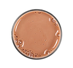 Chocolate milk puddle in glass isolated on white background, top view