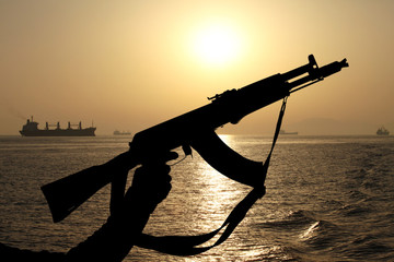 silhouette of machine gun in male hands