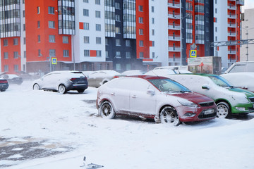snow-covered cars in the city