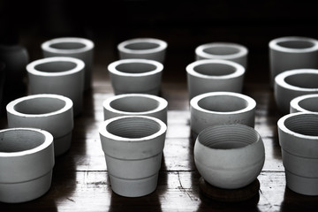 white clay ceramic planting pots on wooden table