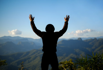 Men raise their arms on the mountain, thank God.