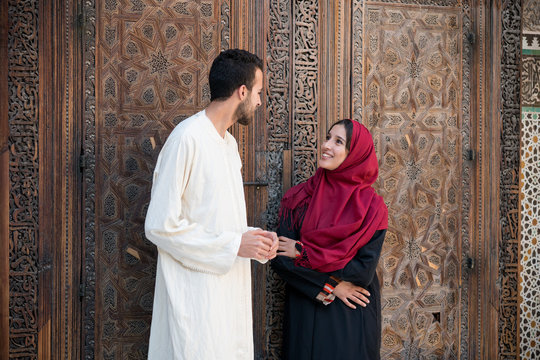 Muslim couple in relationship talking and smiling