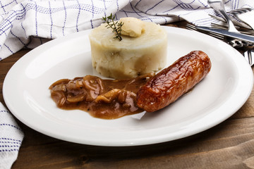 banger and mash with some irish butter on a plate