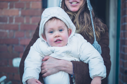 Mother with warmly dressed baby outside