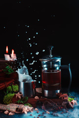 Obraz na płótnie Canvas French press with coffee and a milk jug on a dark background with a milk splash. Action food photography. Alternative coffee brewing concept.