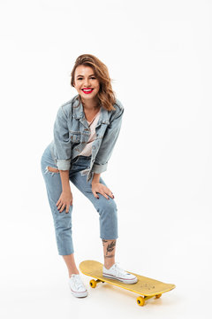 Full length image of Pleased woman in denim clothes posing