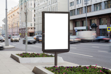 Fototapeta premium Blank mock up of vertical street poster billboard on city background