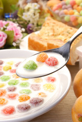 Spoon full of cereals balls and milk   