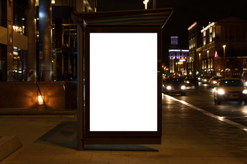 Blank white mock up of vertical light box in a bus stop at night © Павел Хаустов