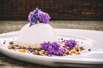Ice cream with lavender, honey, chocolate and coconut shavings on old wooden table. Side view, Close-up