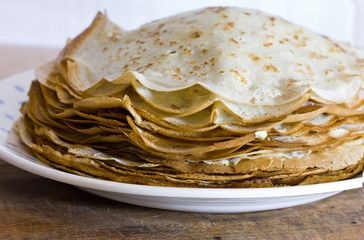 Homemade thin pancakes with butter. Dish of Russian cuisine.