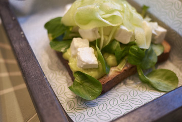 Milan, Italy - December 17, 2017 : Avocado toast with cucumber and feta