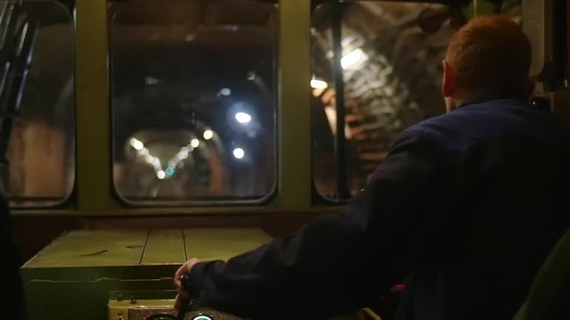 A subway train operator is driving the train