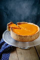 Pumpkin cheesecake on wooden background