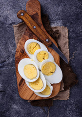 Fototapeta na wymiar Boiled sliced chicken eggs on cutting board