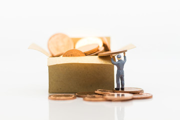 Workers take coins into boxes, boxes full of coins. Image use for business concept, miniature people.