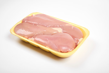 Raw chicken fillet package isolated on white background.