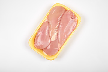 Raw chicken fillet package isolated on white background.