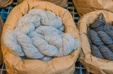 Grey wool yarn in raw paper containers