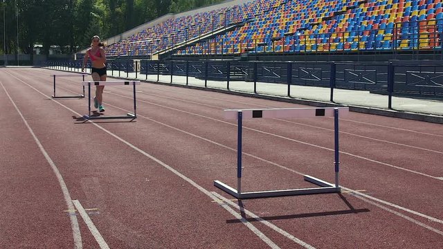 Female gymnast running hurdle race, preparation for important competition