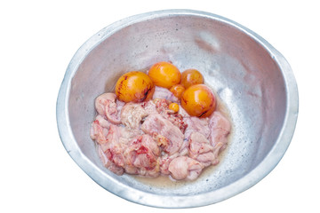 The fresh internal organs of chicken and raw eggs in a zinc bowl, isolated on white background with clipping path.