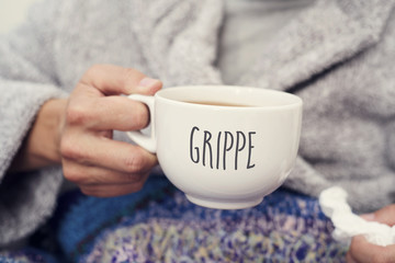 ill man and mug with word grippe, flu in french - obrazy, fototapety, plakaty