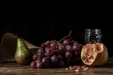 Zelfklevend Fotobehang Pictorial still life with grapes, pears and pomegranate. © funkyfrogstock