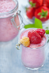 Detox smoothie with strawberries and raspberries in a tall transparent glass of glass. Healthy Breakfast.